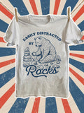 Women's T-Shirt Easily Distracted By Rocks Sitting Bear Surrounded By Stacked Stones And Pebbles