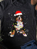 Women's T-Shirt Playful Christmas Lights With Snowflakes And Festive Santa Hat Dog