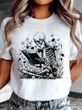 Women's T-Shirt Vintage Skeleton Reading Among Wildflowers And Butterflies In Garden