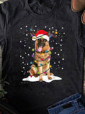 Women's T-Shirt Cute Festive Lights Wrapped German Shepherd Under Falling Snow