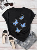 Women's T-Shirt Whimsical Soft Blue Butterflies Flying Against Solid Silky Black Shirt
