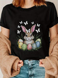 Women's T-Shirt Whimsical Scene With Painted Eggs Among Spring Grass And Playful Bunny Rabbit