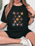 Women's T-Shirt Vibrant Pastel Colored Pattern On Soft Black Starfish