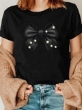 Women's T-Shirt Elegant Satin Bow With Shimmering Pearls On Black Fabric Bow