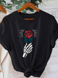 Women's T-Shirt Radiant Rose Held By A Skeleton Hand Under Shining Light