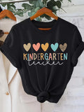 Women's T-Shirt Multicolored Pastel Hearts With Playful Text And Dotted Pattern Kindergarten Teacher