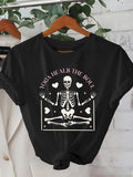 Women's T-Shirt Yoga Heals The Soul Skeleton Surrounded By Floating Hearts In Meditative Pose