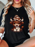 Women's T-Shirt Cute Brown Highland Cow Wearing Cozy Patterned Winter Hat