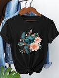 Women's T-Shirt Delicate Pink Flowers And Flourishing Greenery Adorn Tranquil Sea Turtle