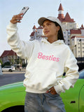 Women's Hoodie Besties Pastel Pink Lettering On Cozy White Hoodie With Cityscape Background