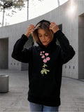 Women's Hoodie Elegant Pink Flowers With Lush Green Leaves On A Calm Day Hoodie