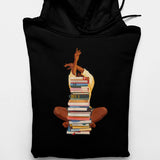 Men's Hoodie Person Sitting Cross Legged Behind A High Stack Of Colorful Literature Books